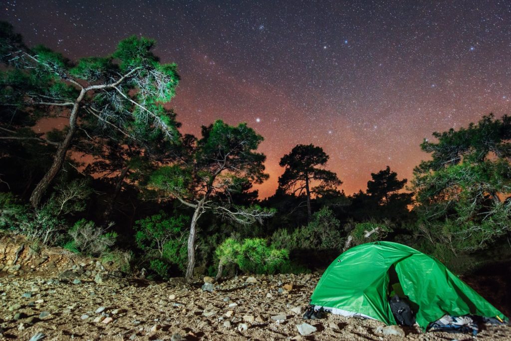 Camping under the stars. Green solo tent dark night sky