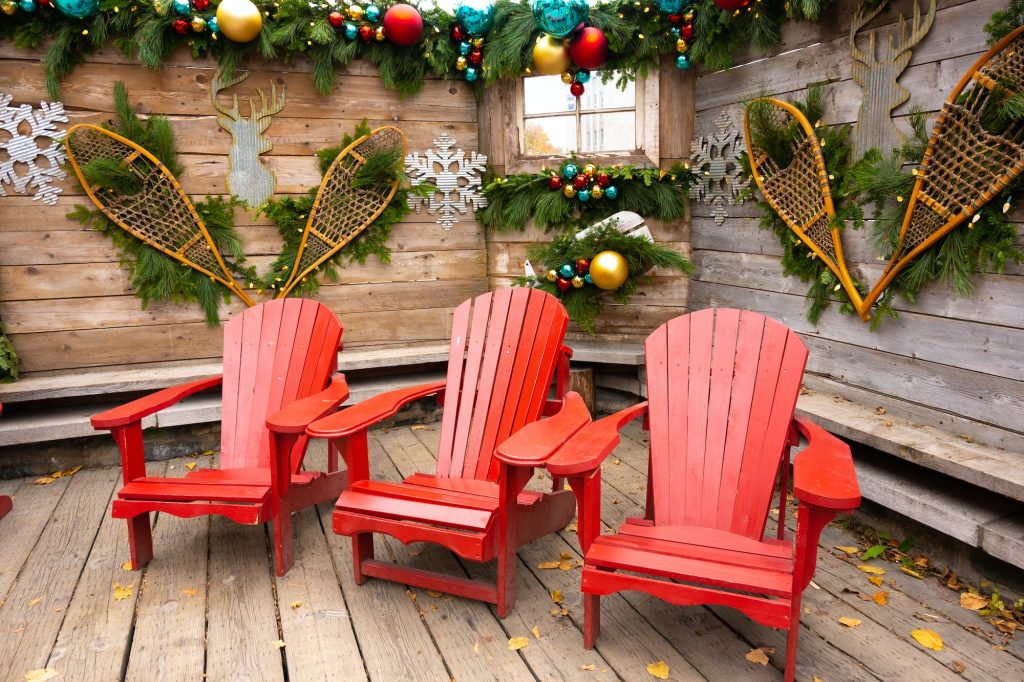Rustic winter bungalow, red Adirondack chairs
